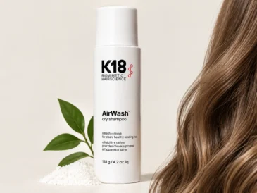 K18 dry shampoo AirWash bottle on a neutral background